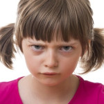 angry little girl on white background